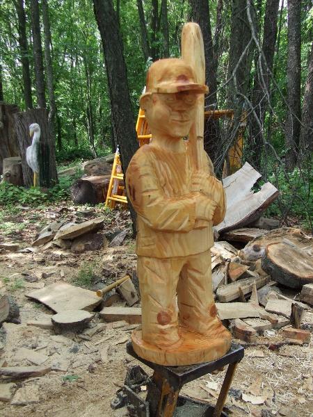 chainsaw carving boy baseball player