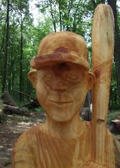 chainsaw carving boy baseball player